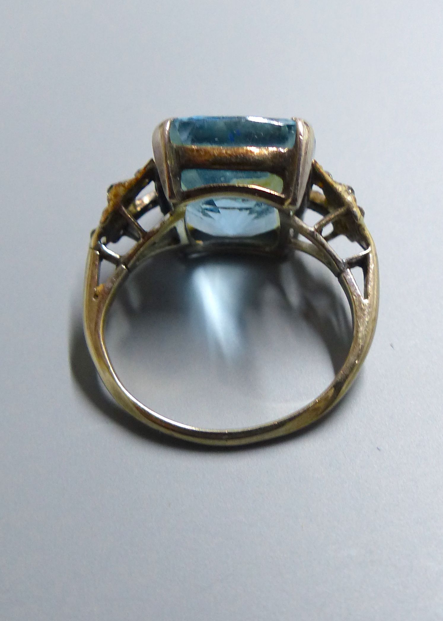 An early 20th century yellow metal, aquamarine and white stone chip set dress ring, size J, gross 5.2 grams.